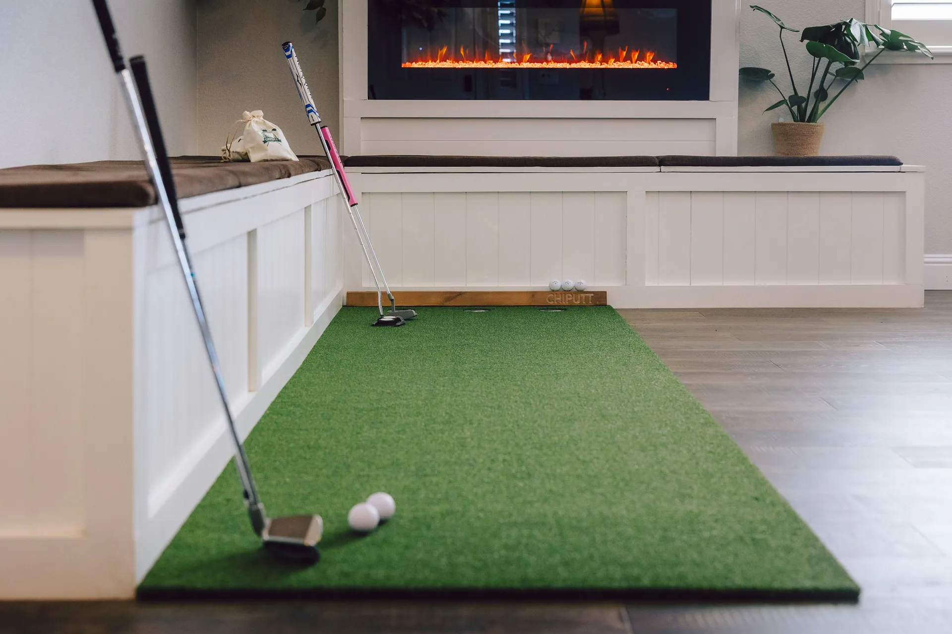 Indoor golf mat set up in a home