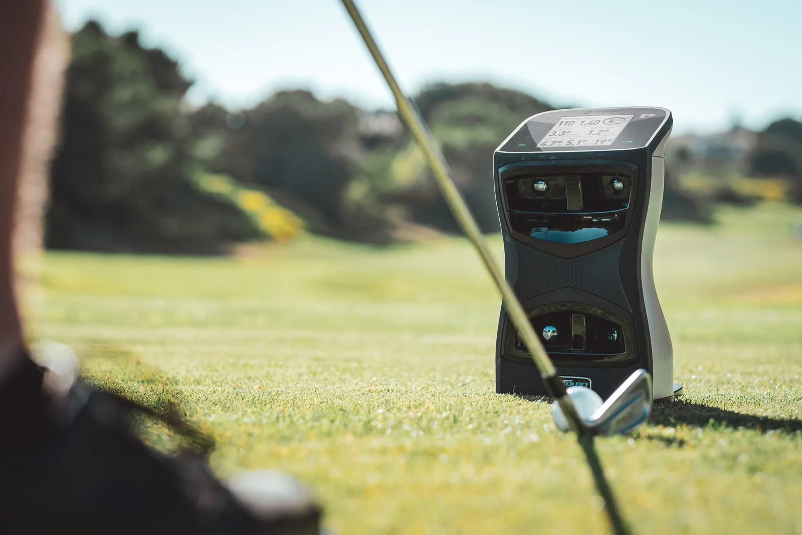 Foresight GCQuad on the grass beside a golf ball